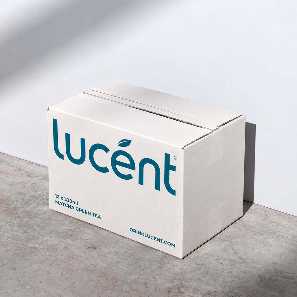 Three slim Lucent Matcha Focus zero sugar energy drinks cans on a white background: a teal Classic matcha can on the left, a pale blush pink White Peach can in the center, and a magenta Passion Mango can on the right.