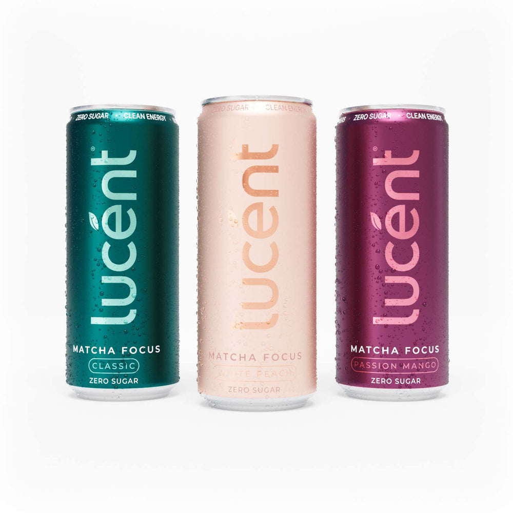 Three slim Lucent Matcha Focus zero sugar energy drinks cans on a white background: a teal Classic matcha can on the left, a pale blush pink White Peach can in the center, and a magenta Passion Mango can on the right.