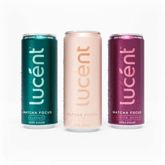 Three slim Lucent Matcha Focus zero sugar energy drinks cans on a white background: a teal Classic matcha can on the left, a pale blush pink White Peach can in the center, and a magenta Passion Mango can on the right.