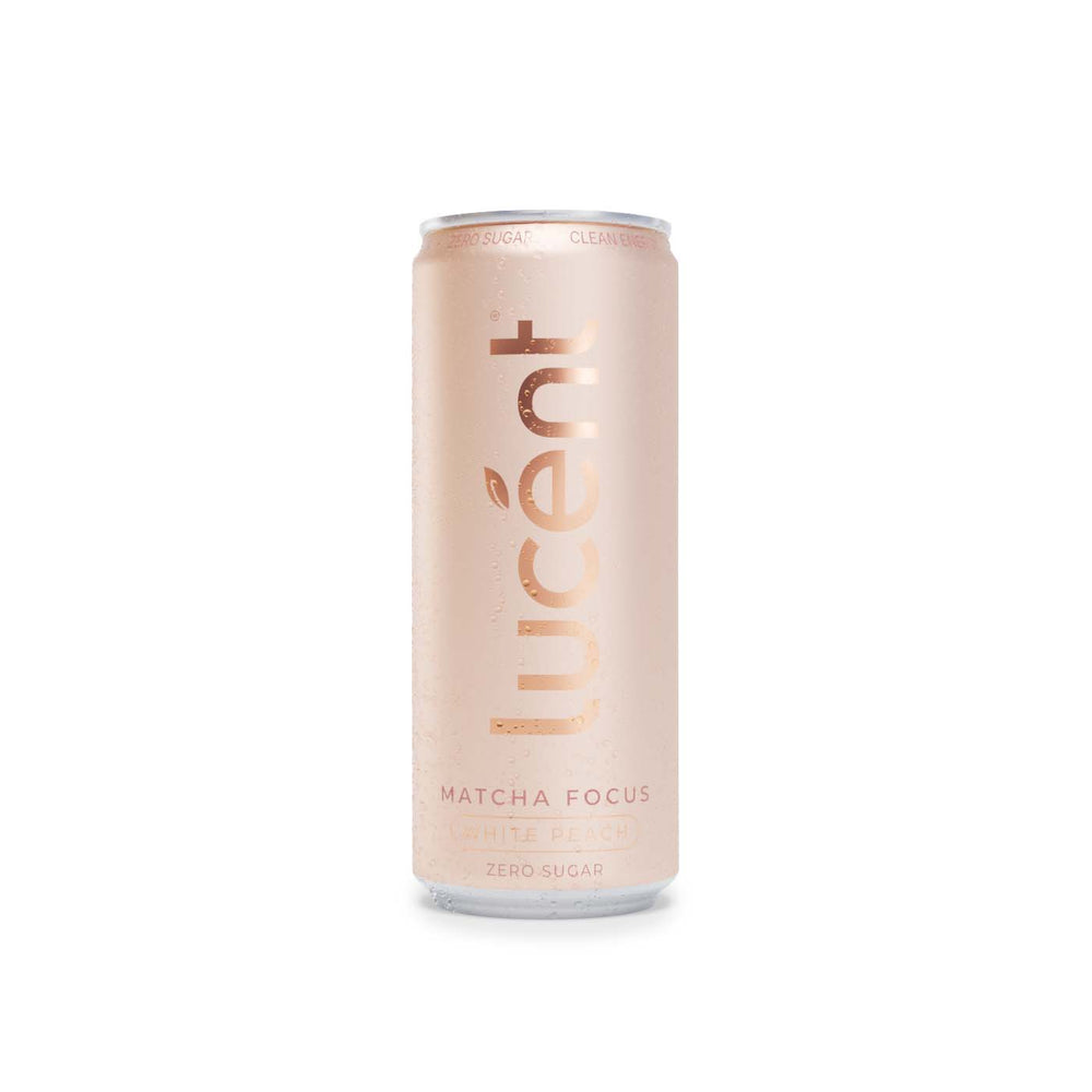 A single can of Lucent Matcha Focus White Peach zero sugar beverage, featuring a metallic pink can with condensation droplets, set against a plain white background.