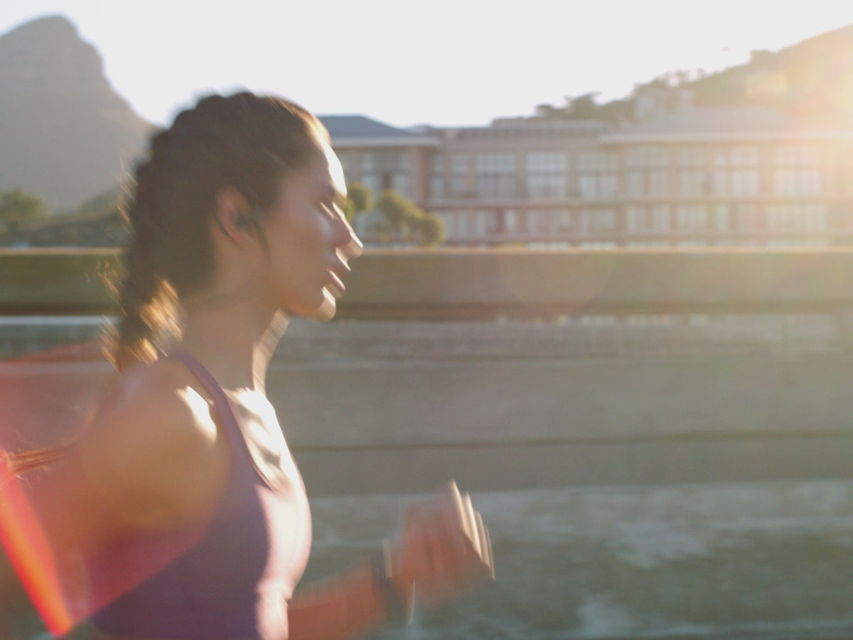 Load video: Lucent matcha green tea energy drink in soft natural light, showing a minimalist zero sugar beverage.